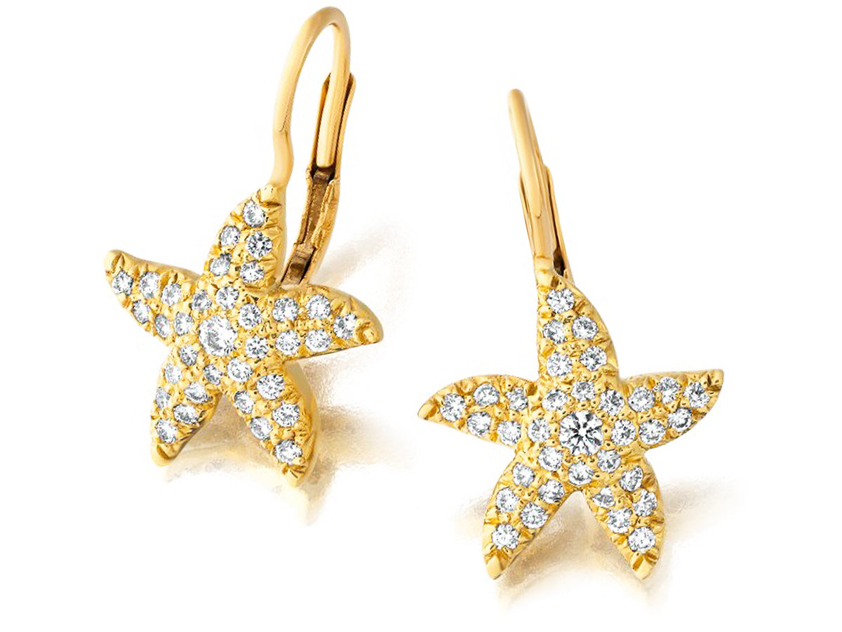 Gold starfish earrings with diamonds on a white background