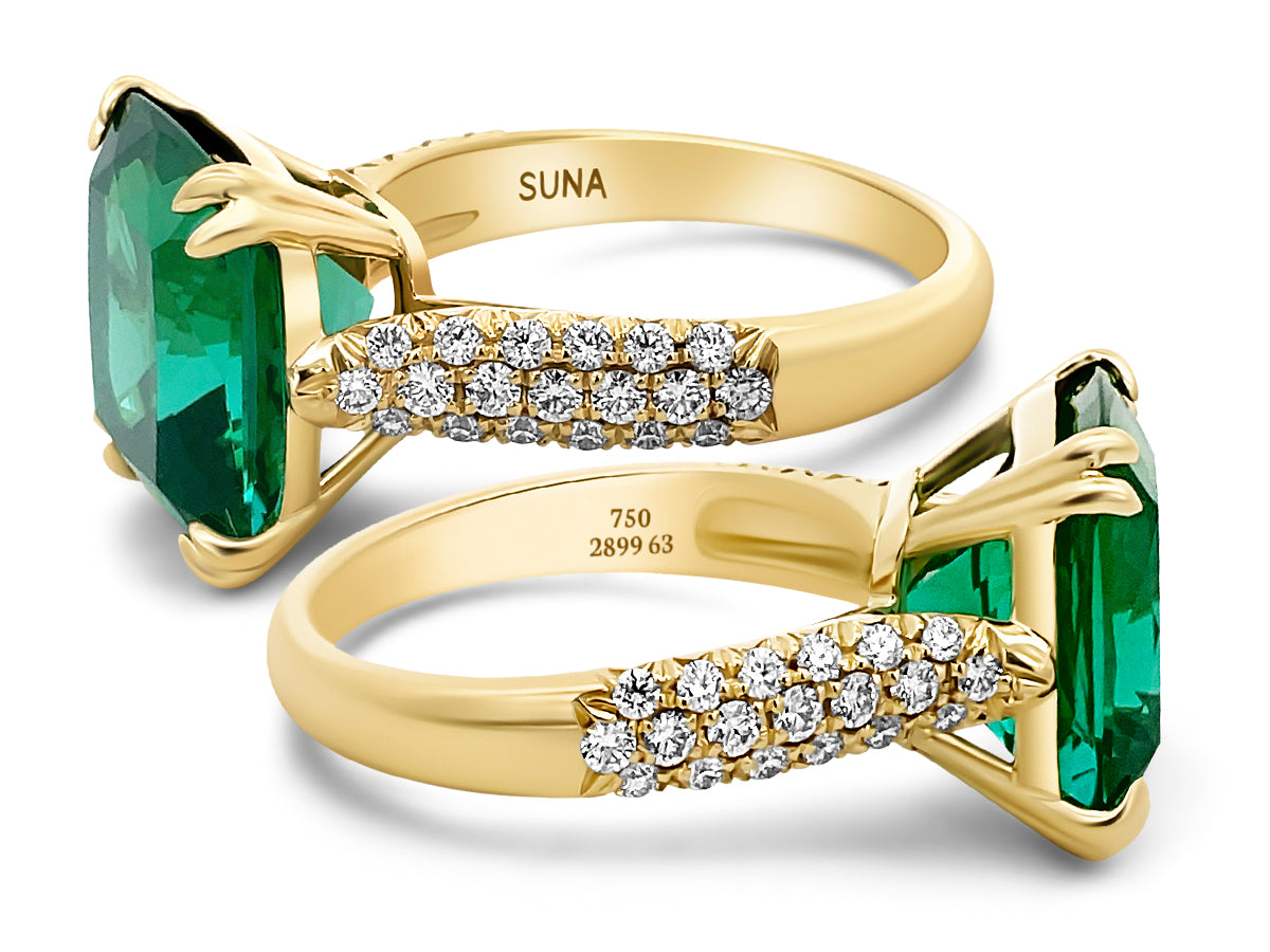 Two gold rings with green gemstones and diamonds stamped SUNA, karat of gold, and serial number.