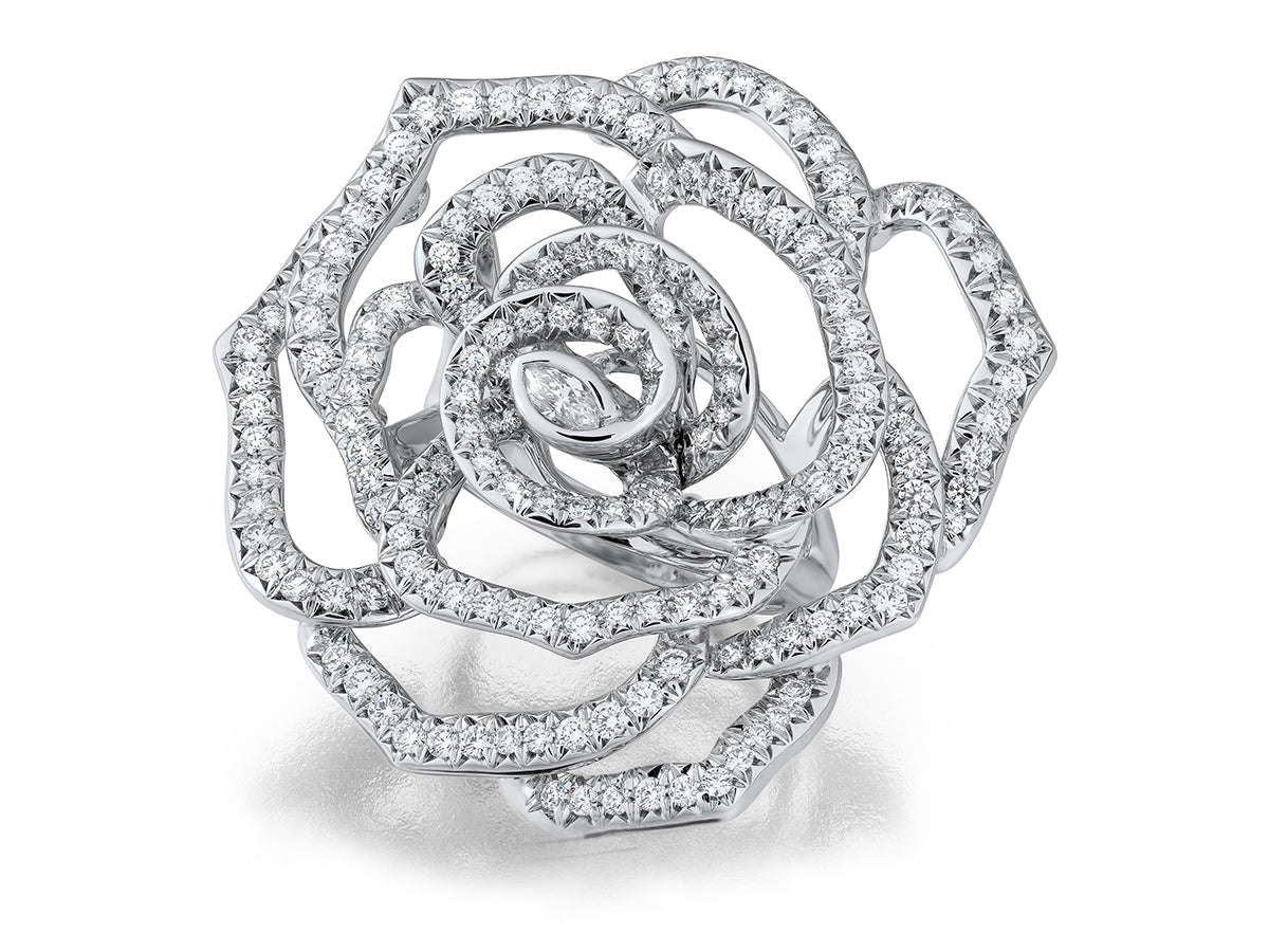 Diamond-encrusted rose-shaped ring on a white background