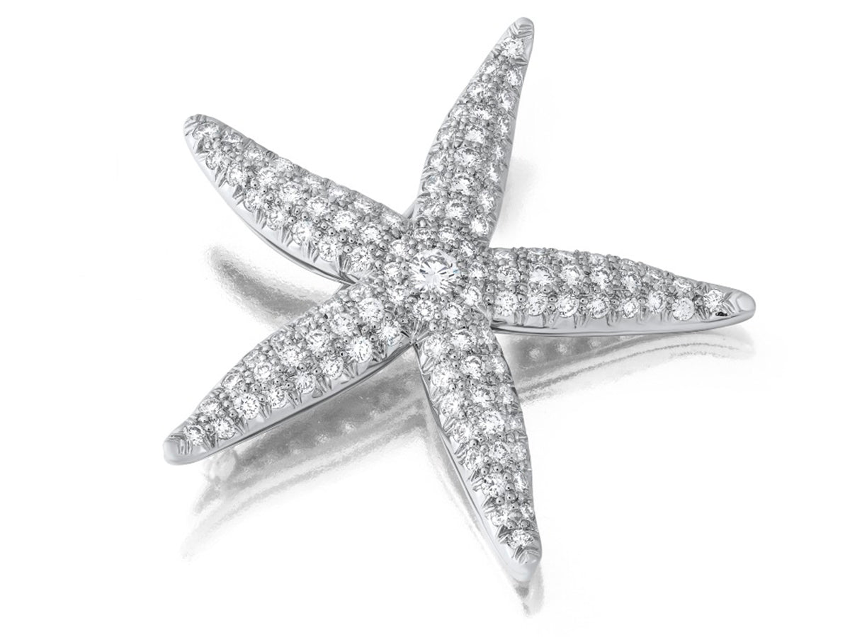 Starfish brooch with diamonds on a white background