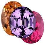 Three colorful gemstones on a white background