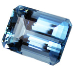 Blue gemstone with a rectangular cut on a white background