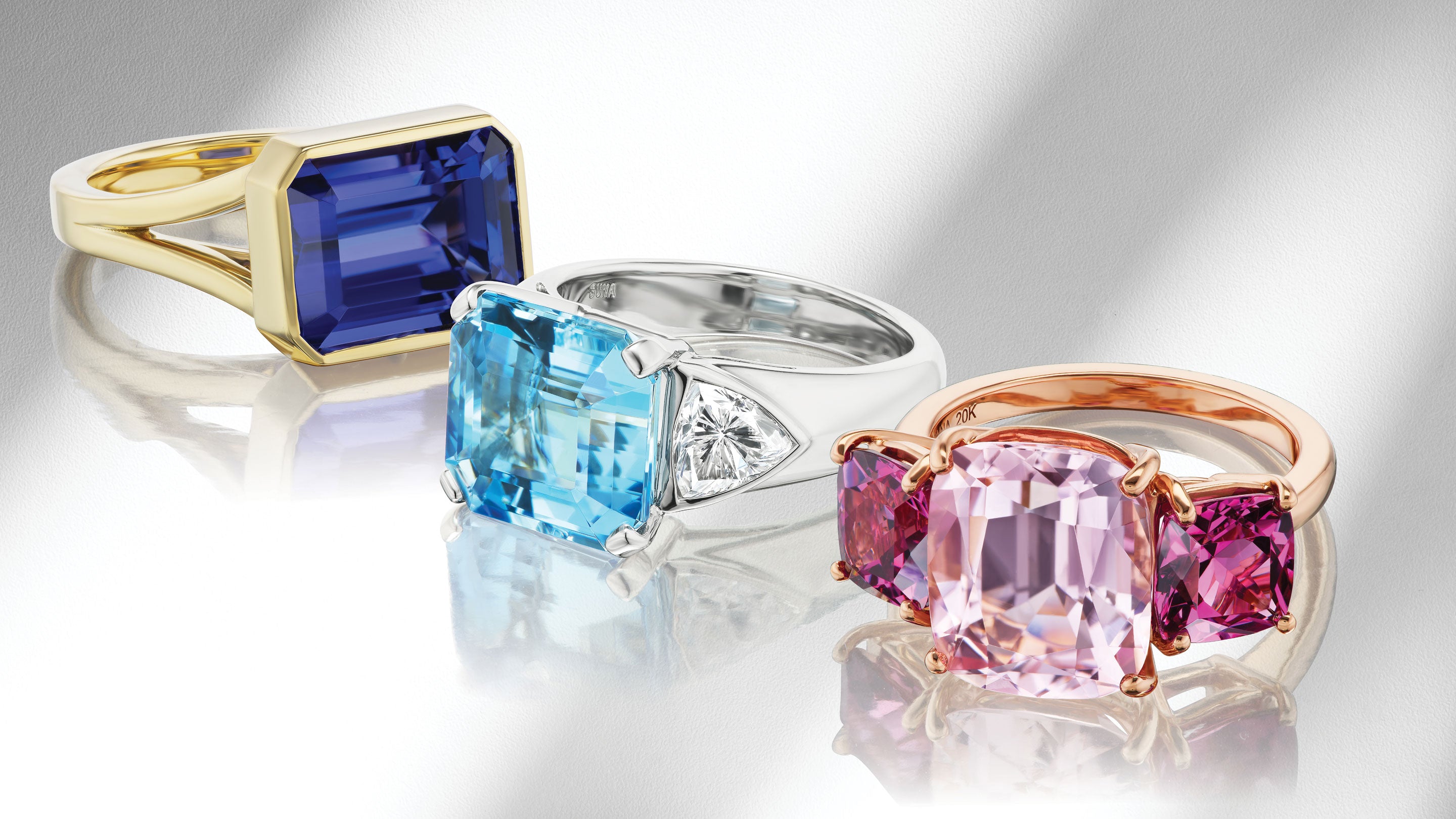 Rings with colorful gemstones on gray background