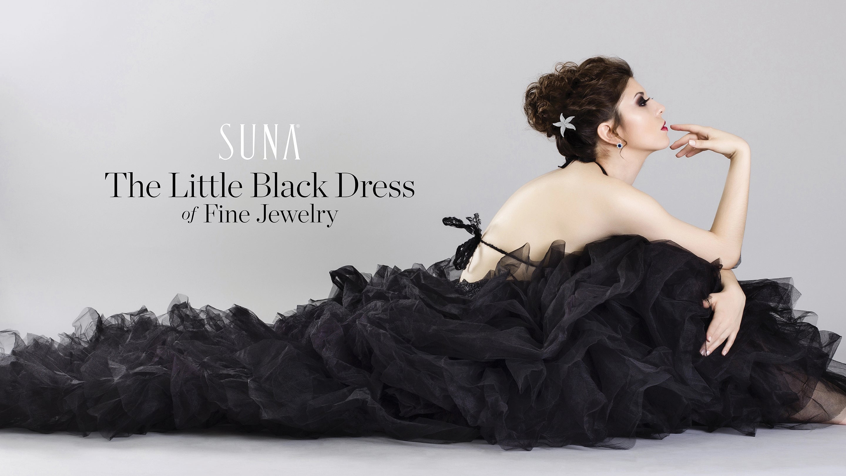 Woman in a long black dress with 'SUNA' and "The Little Black Dress of Fine Jewelry" text.