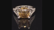 Video of rotating 18K white gold ring with brown-gold zircon and diamonds on black background