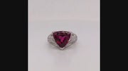 Video of rotating platinum ring with a trilliant rubellite and diamonds on a white background