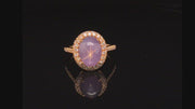 Video of rotating ring with lavender  gemstone and diamonds on black background