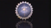 Video of rotating platinum ring with large blue-gray star sapphire and brilliant diamonds on a black background.