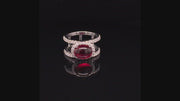 Video of rotating ring with red gemstone and diamonds on black background