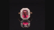 Video of rotating rubellite set in platinum with diamonds on 20K pink gold ring on black background.