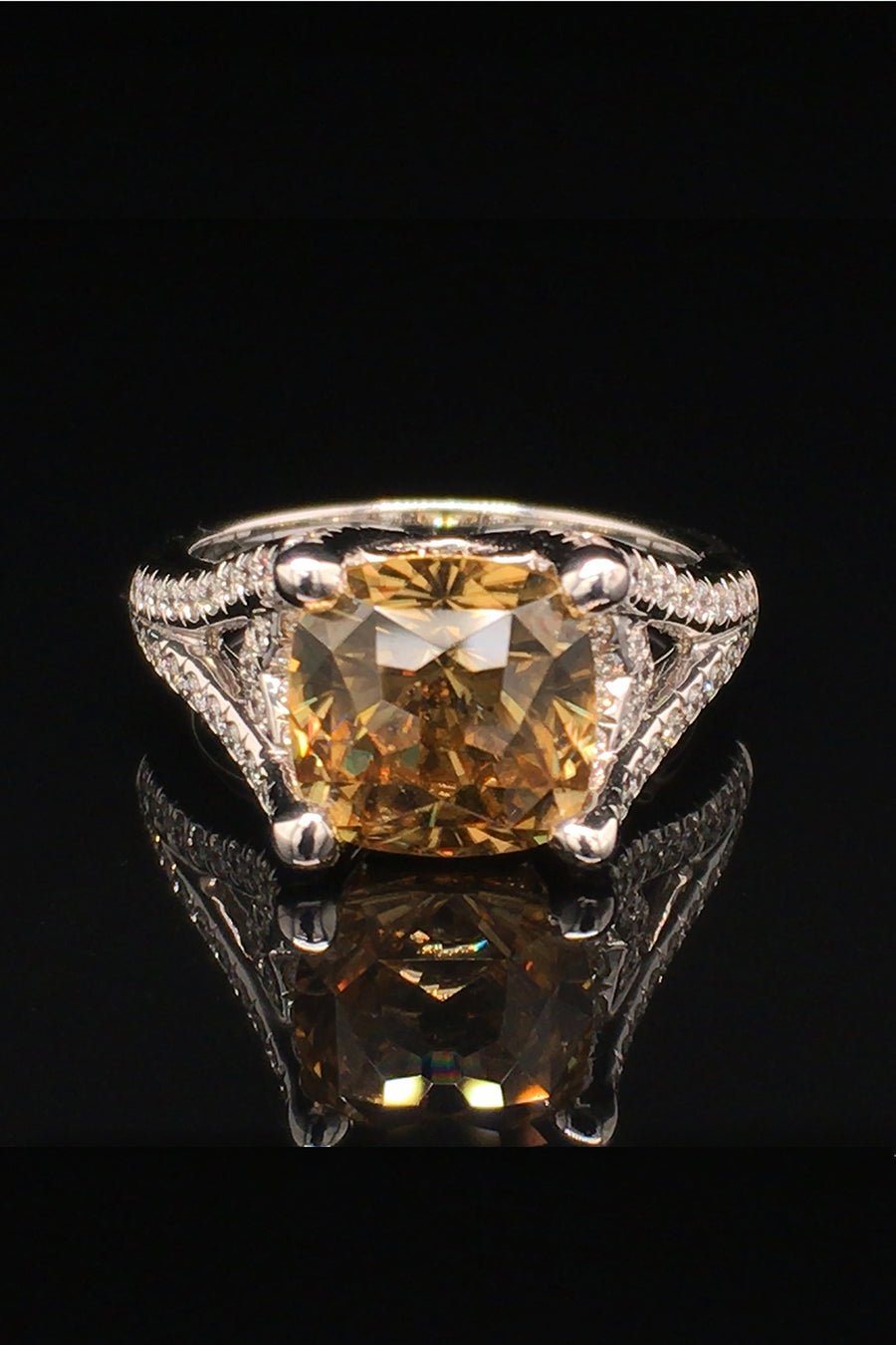 18K white gold ring with a golden zircon and diamonds on a black background.