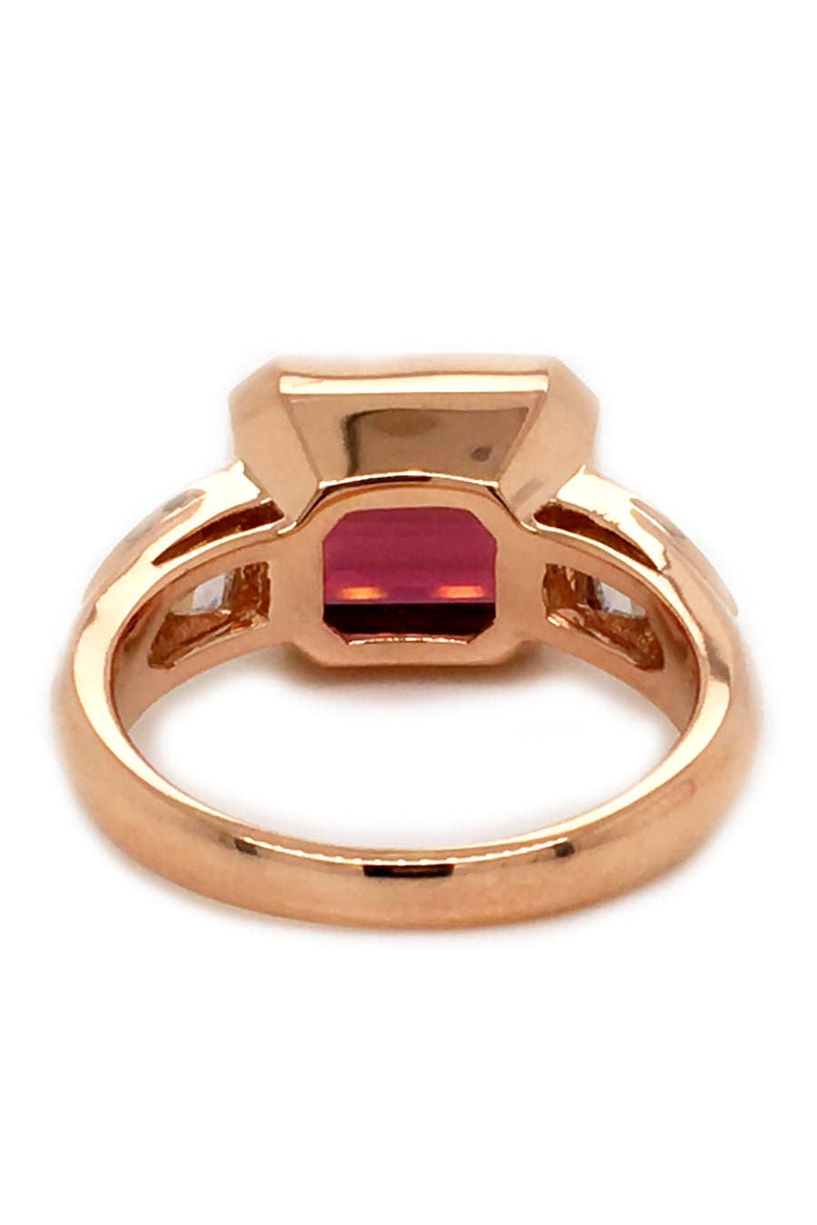 Back view of 20K pink gold ring with a rubellite and diamonds on white background.