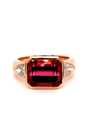 20K pink gold ring with a rubellite and diamonds on white background.