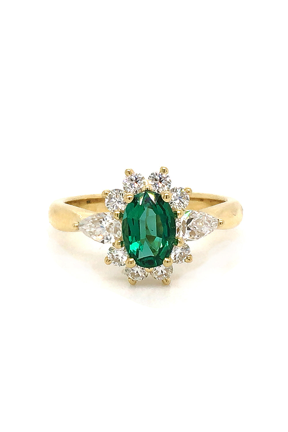 18K gold ring featuring an oval emerald with diamonds on a white background
