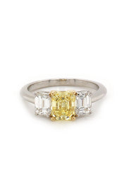 Ring with canary diamond with 18K yellow gold prongs and diamonds set in a platinum on white background