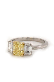 Angle view of ring with canary diamond with 18K yellow gold prongs and diamonds set in a platinum on white background