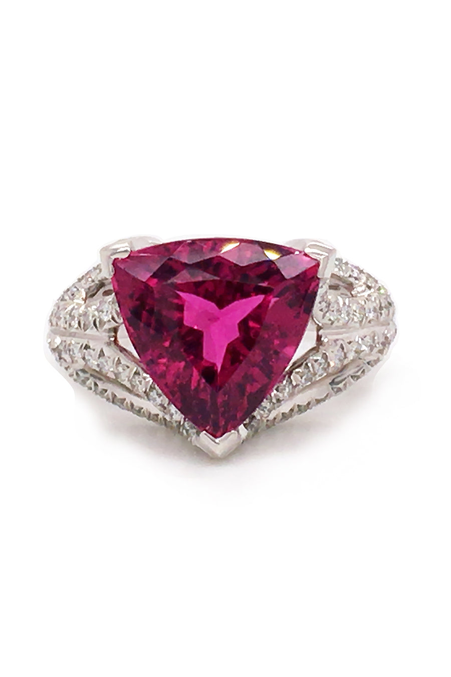 18K white gold ring featuring a large trilliant cut rubellite with diamonds on a white background