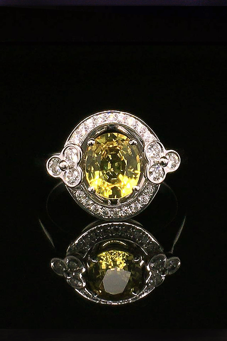 18K white gold ring with a yellow sapphire and lace motif with diamonds on a black background