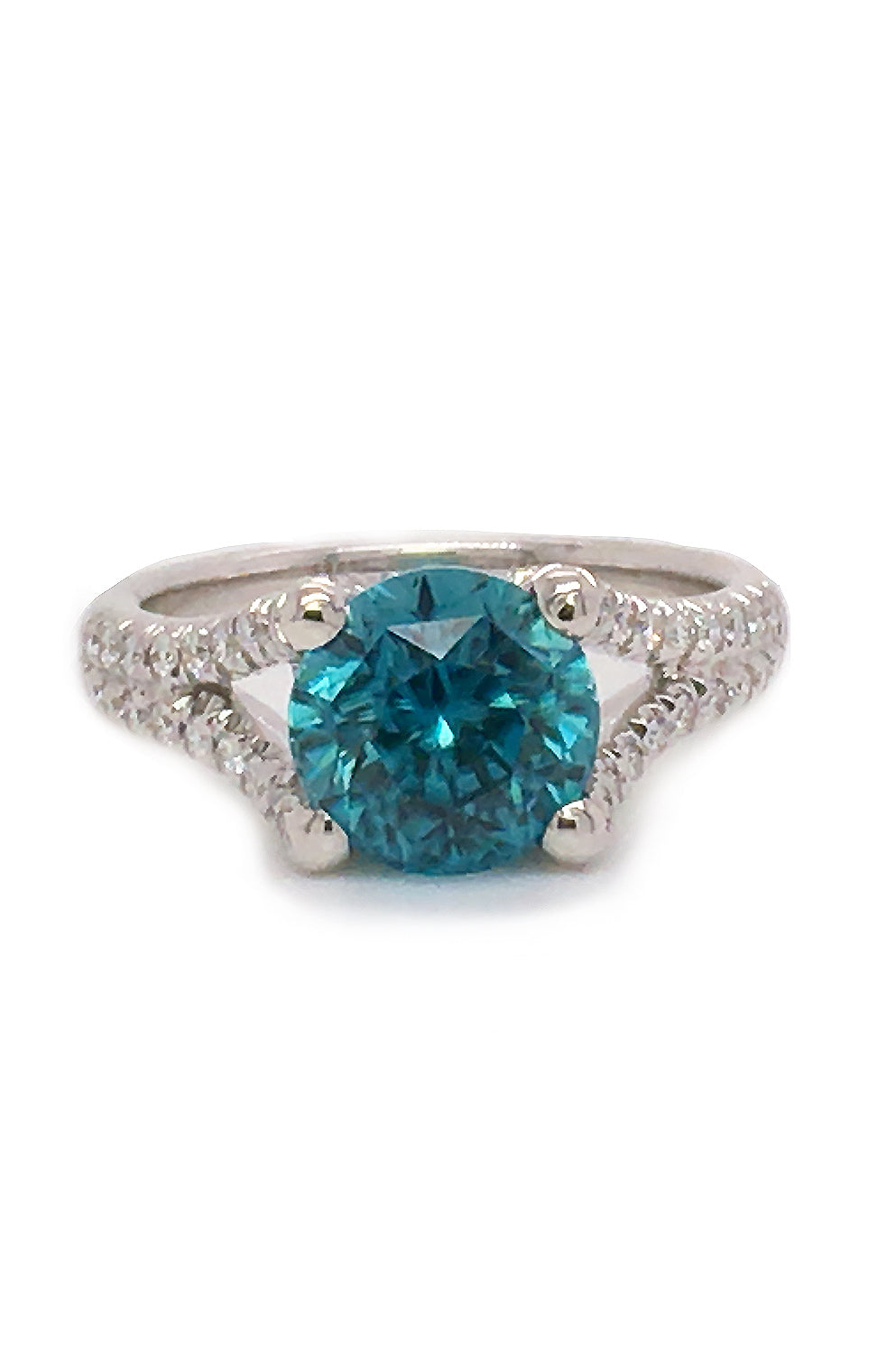 18K white gold ring with a blue zircon and diamonds on a white background