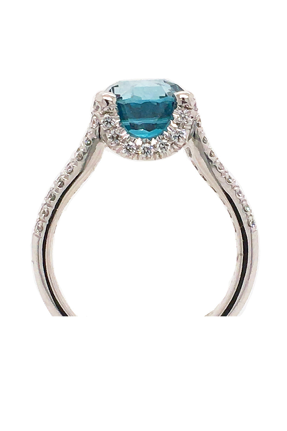 Side view of platinum ring with a blue zircon and diamonds on a white background
