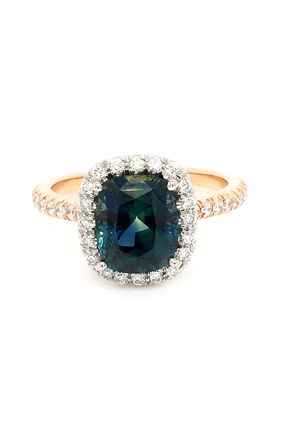 20K pink gold ring with a cushion-cut teal sapphire and diamond halo on a white background.
