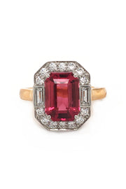 Rubellite set in platinum with diamonds on 20K pink gold ring on white background.