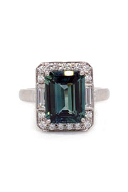 Emerald-cut green sapphire with baguettes and brilliant diamonds in platinum on a white background