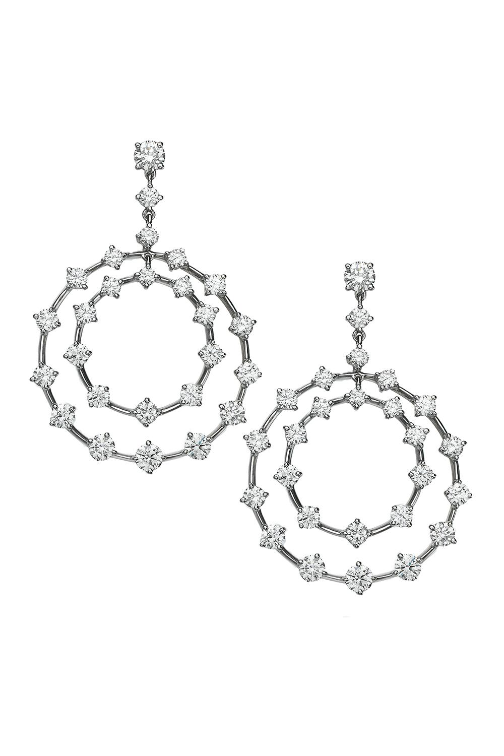 Platinum and diamond earrings featuring a circle design on a white background