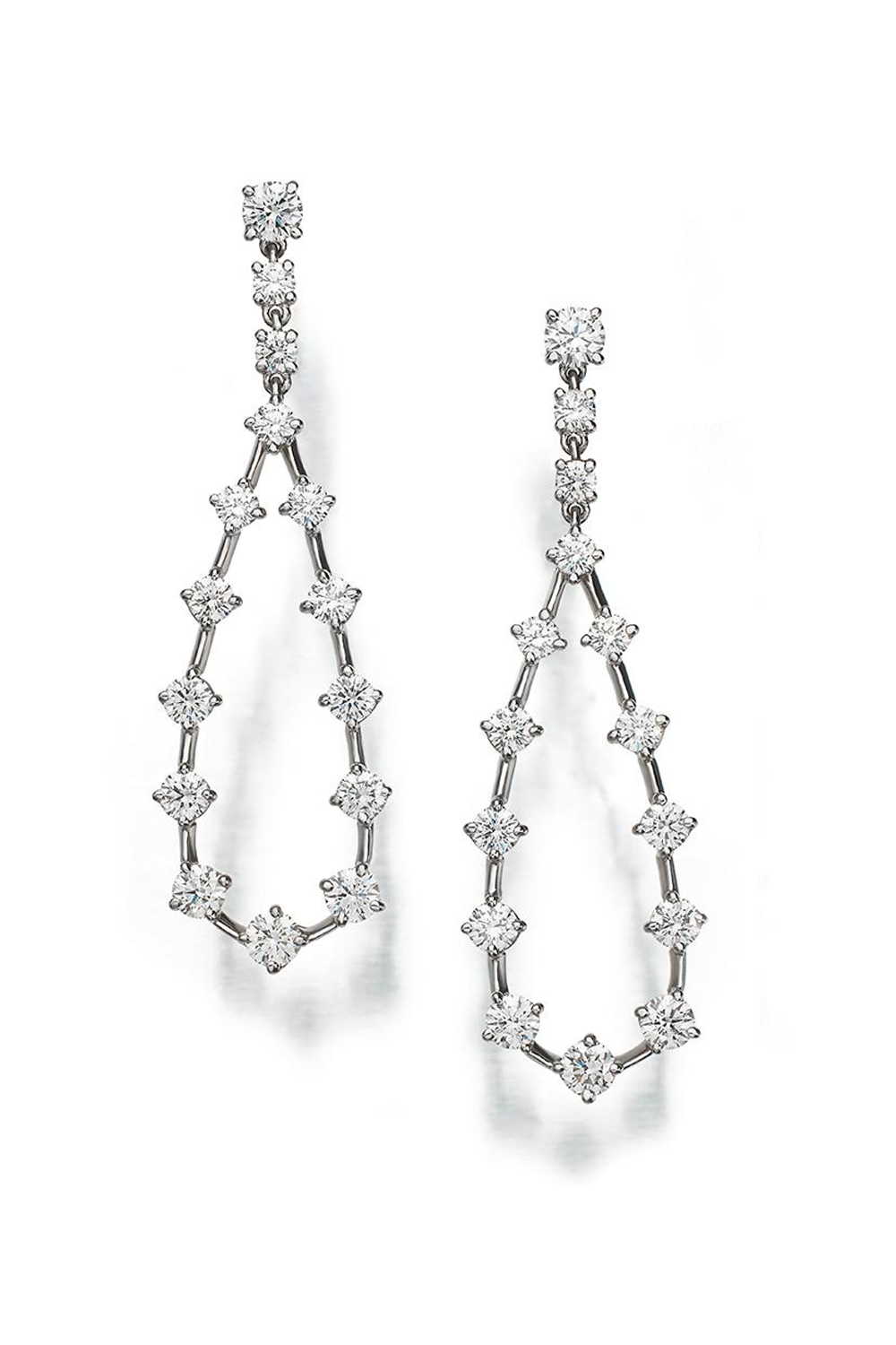 Platinum and diamond earrings featuring a pear- shape design on a white background