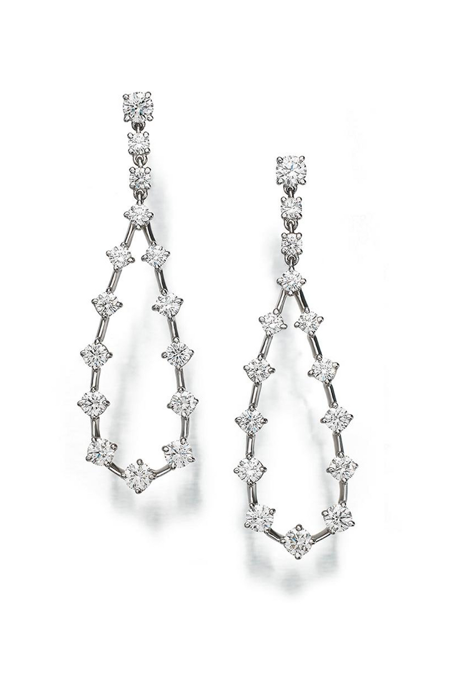 Platinum and diamond earrings featuring a pear- shape design on a white background