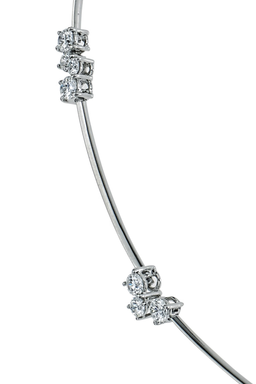 Closeup of platinum wire necklace with diamond clusters on a white background