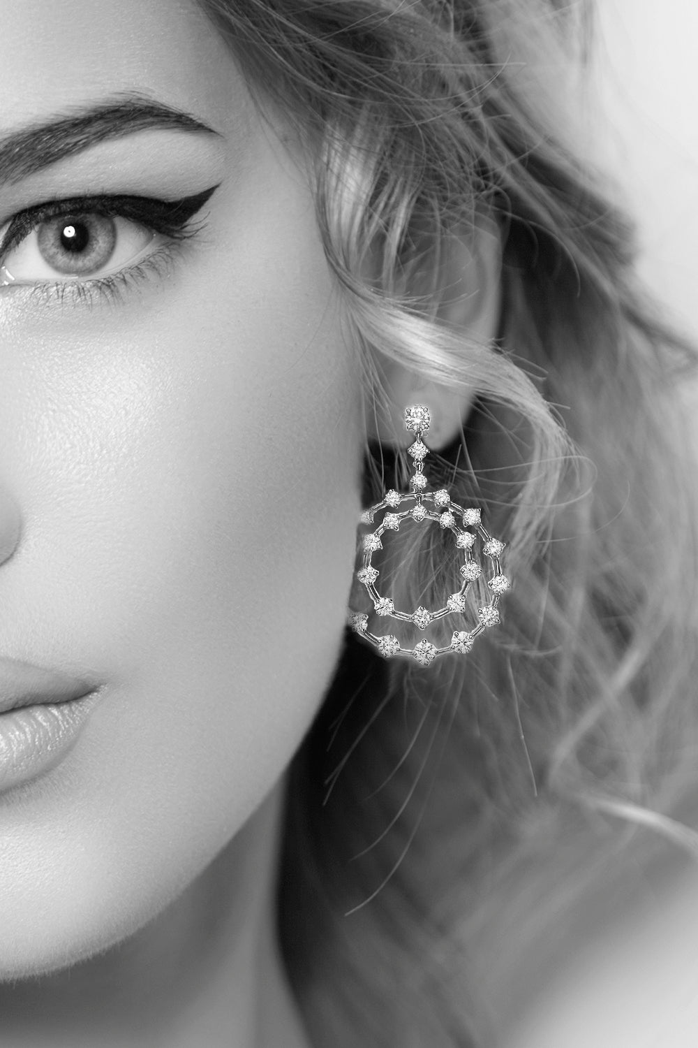 Closeup of woman's ear wearing diamond double circle earrings