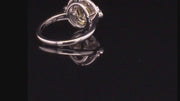 Video of rotating ring with yellow gemstone and diamonds on black background