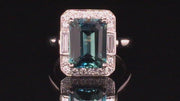 Video of rotating ring with emerald-cut green sapphire with baguettes and brilliant diamonds in platinum on black background