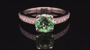 Video of rotating ring with round mint green tourmaline set in a platinum with diamonds on black background