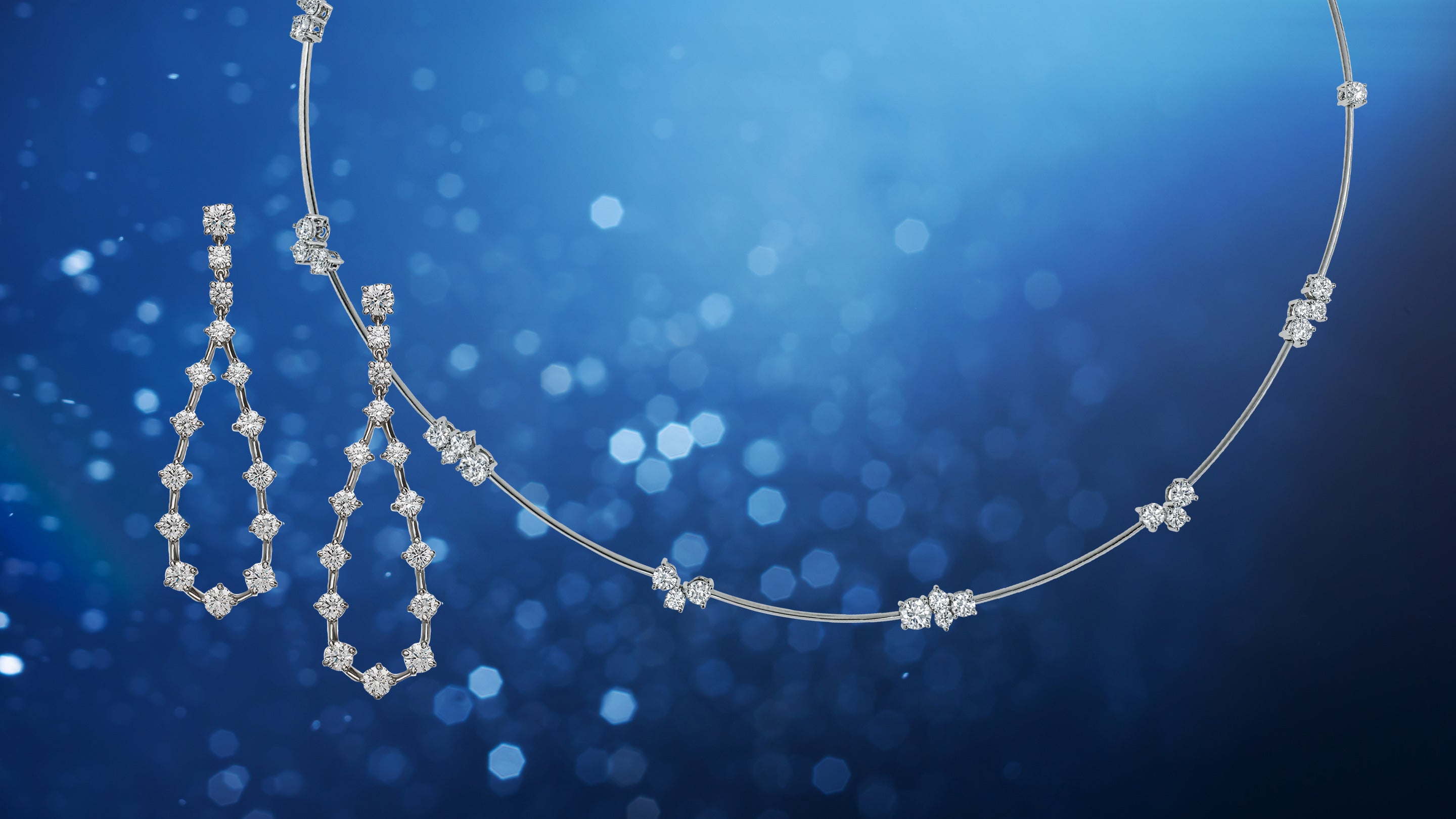 Diamond necklace and earrings on a blue background