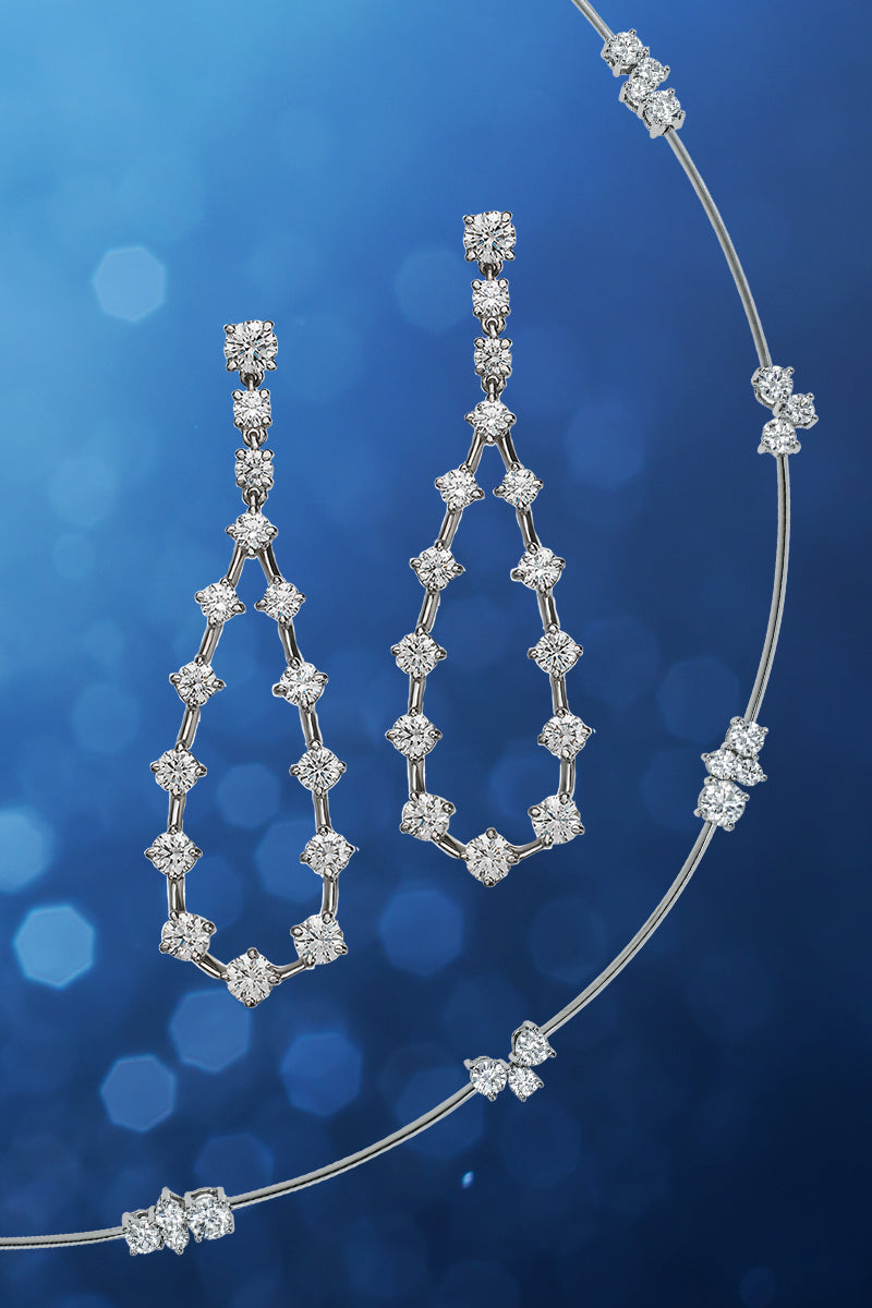 Diamond necklace and earrings on a blue background