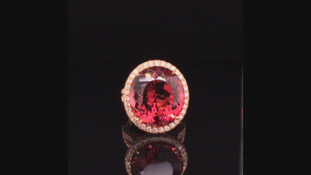 Video of rotating 20K pink gold ring with large oval cinnamon tourmaline and diamonds on black background