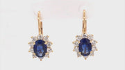 Video of rotating earrings with blue gemstones and diamonds on white background