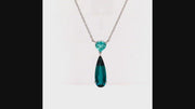 Video of rotating necklace with blue gemstones on white backgroound