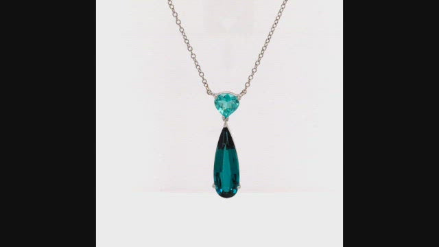 Video of rotating necklace with blue gemstones on white backgroound