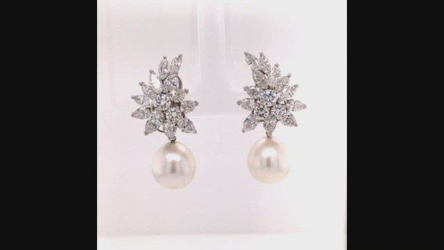 Video of rotating pearl earrings with a platinum cluster with marquise, pear-shaped, and brilliant-cut diamonds on a white background