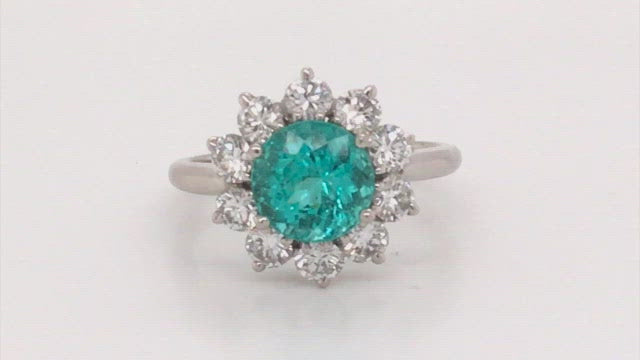 Video of rotating platinum ring with paraiba surrounded by diamonds on white background