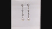 Video of rotating platinum and diamond lace earrings with South Sea cultured pearls on white background