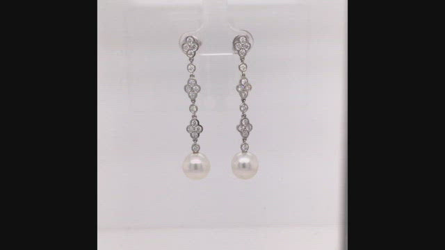 Video of rotating platinum and diamond lace earrings with South Sea cultured pearls on white background