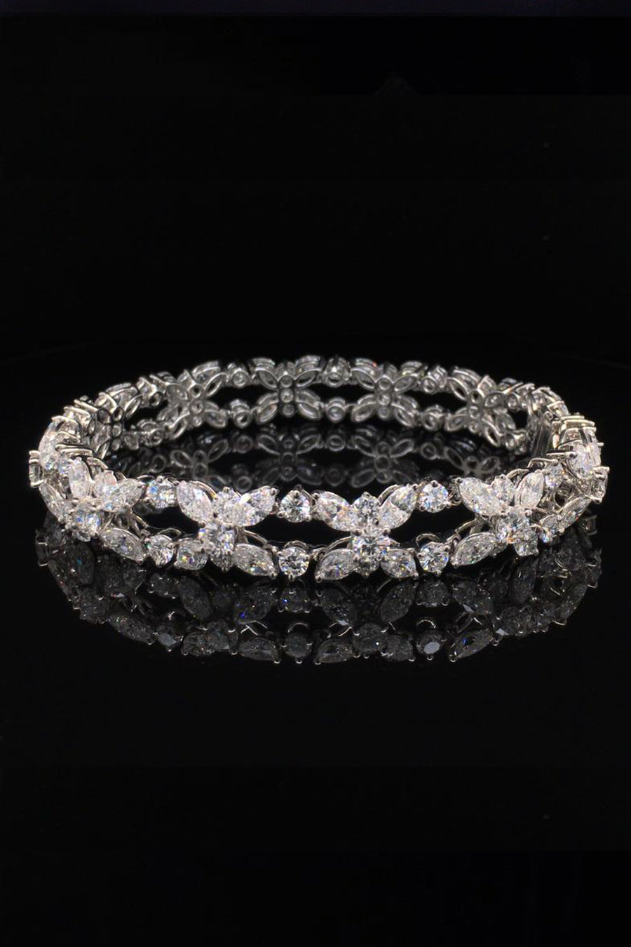 Platinum bracelet with marquise and brilliant diamonds on a black background.