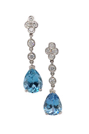 Platinum drop earrings featuring pear-shaped aquamarines suspended from diamond lace detailing on a white background