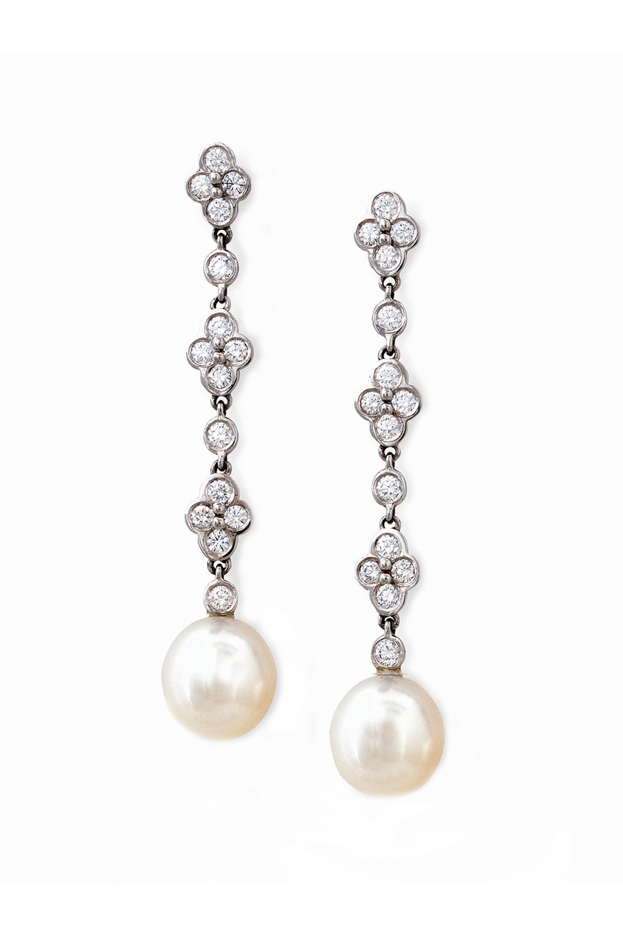 Platinum and diamond lace earrings with South Sea cultured pearls on white background