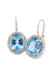 18K white gold earrings featuring large oval aquamarines surrounded with diamonds with lever backs on a white background