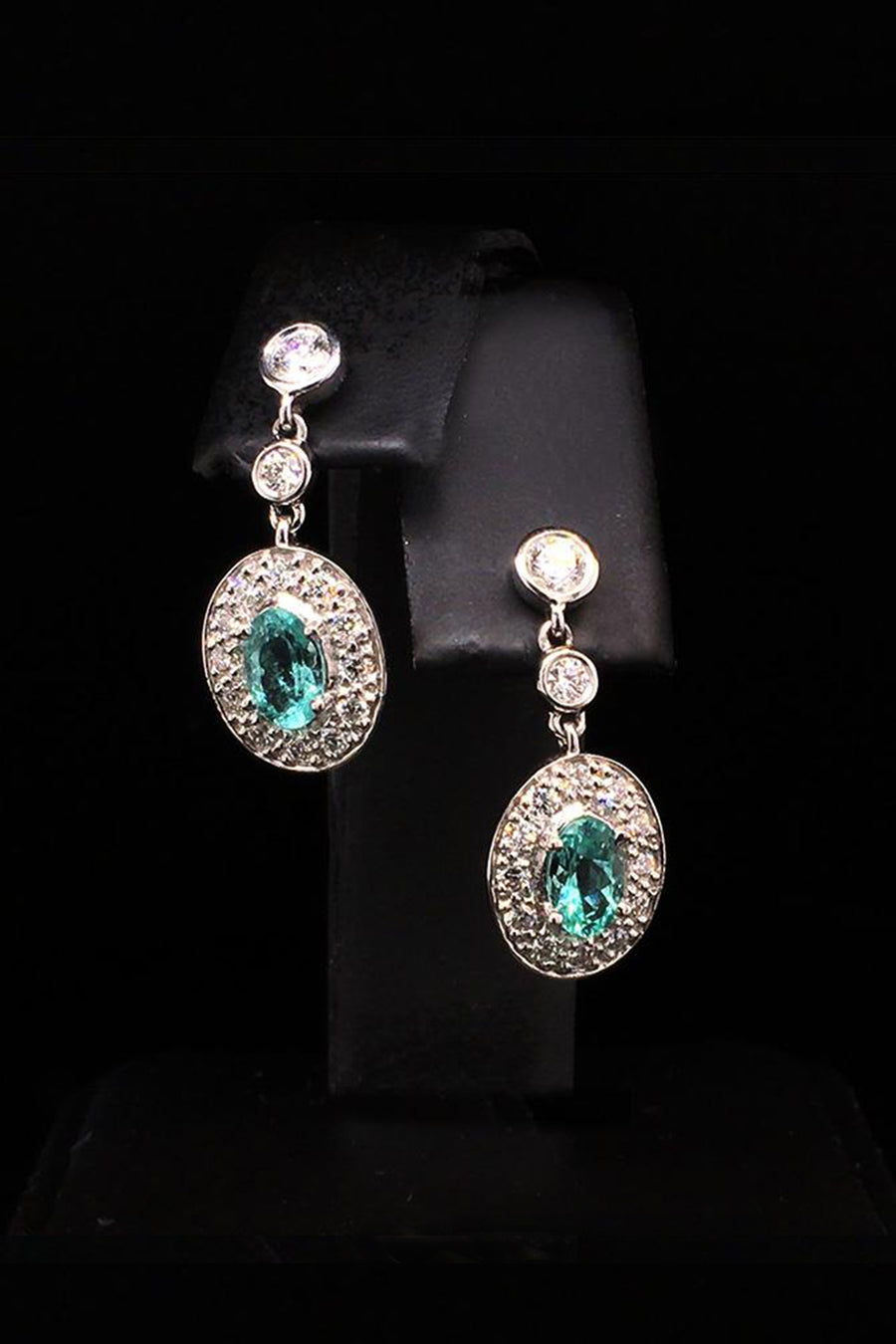 Platinum earrings with African paraibas and diamonds diamonds on a black background